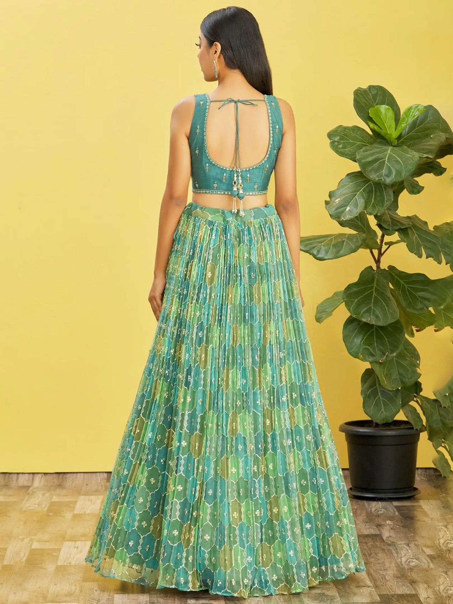 Lehenga set consisting of an embroidered pistachio green choli and a tulle dupatta