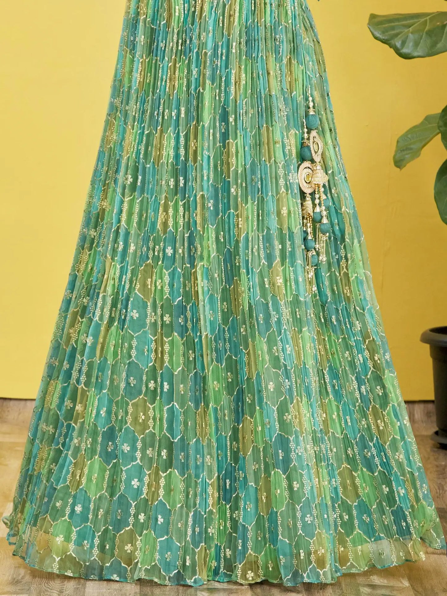Lehenga set consisting of an embroidered pistachio green choli and a tulle dupatta