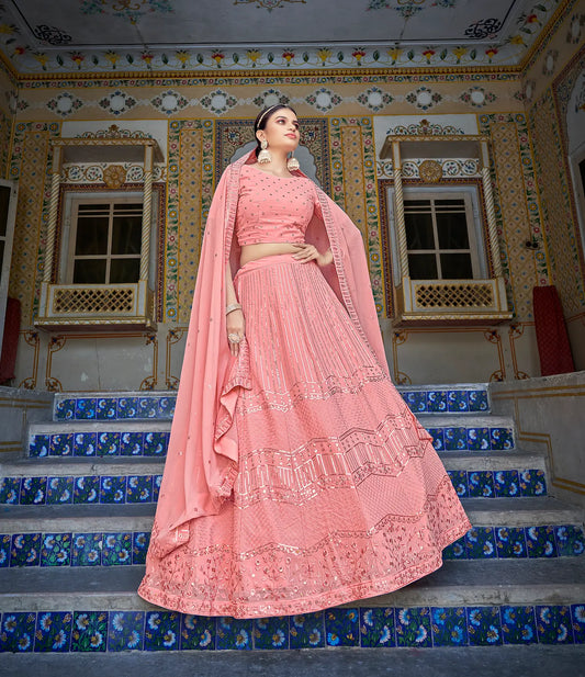 Lehenga choli rose pêche en georgette avec broderies de fils et sequins