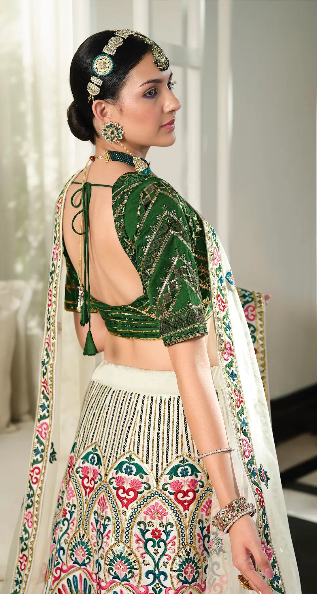 White and green silk lehenga choli with thread embroidery and sequins