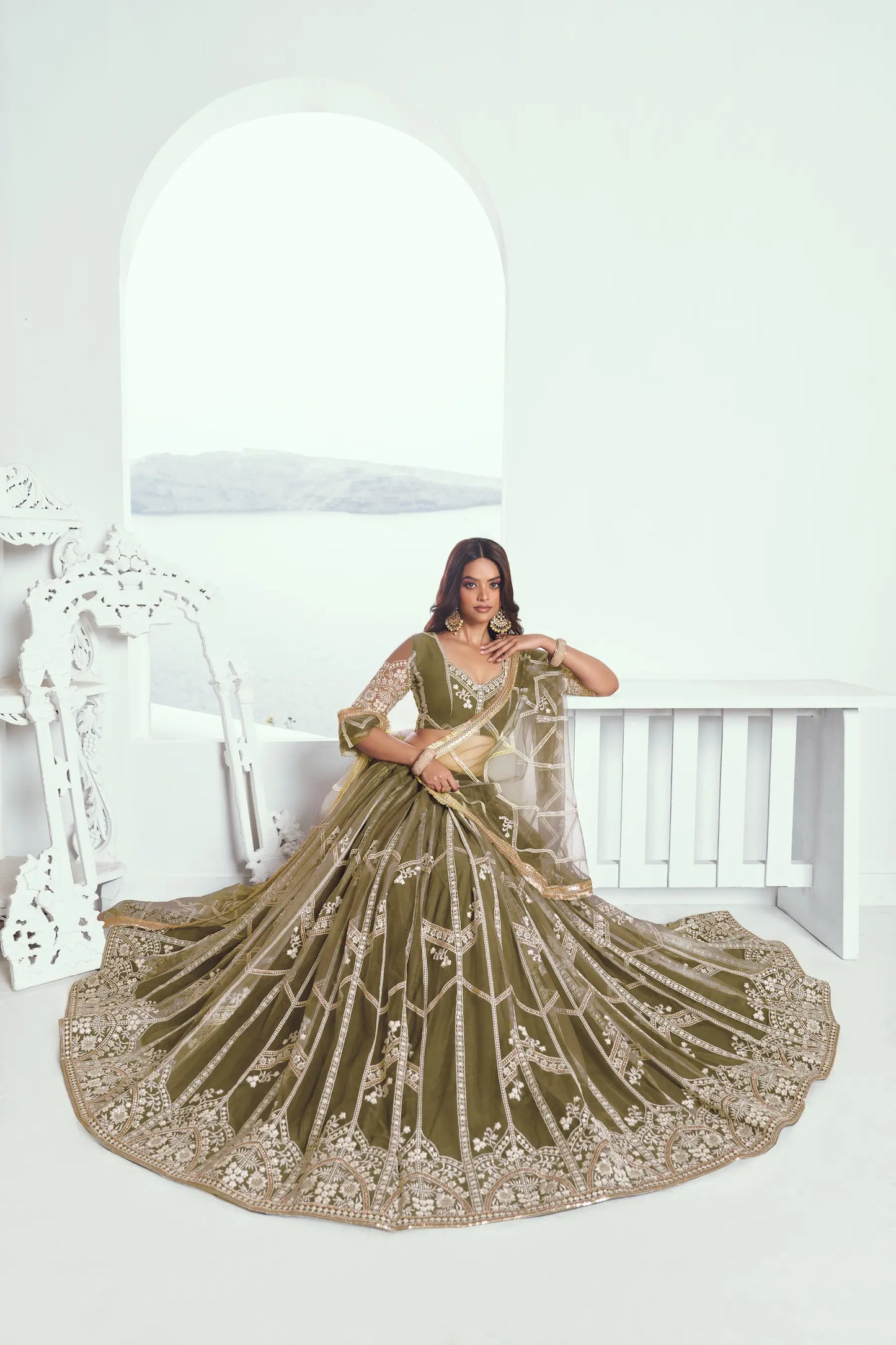 Olive green Lehenga Choli set in net fabric, adorned with delicate cotton thread embroidery and shiny sequins CHANDRALEKHA COLLECTION