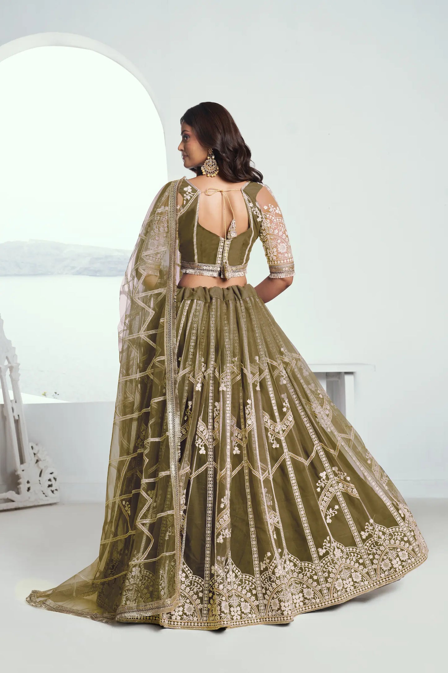 Olive green Lehenga Choli set in net fabric, adorned with delicate cotton thread embroidery and shiny sequins CHANDRALEKHA COLLECTION
