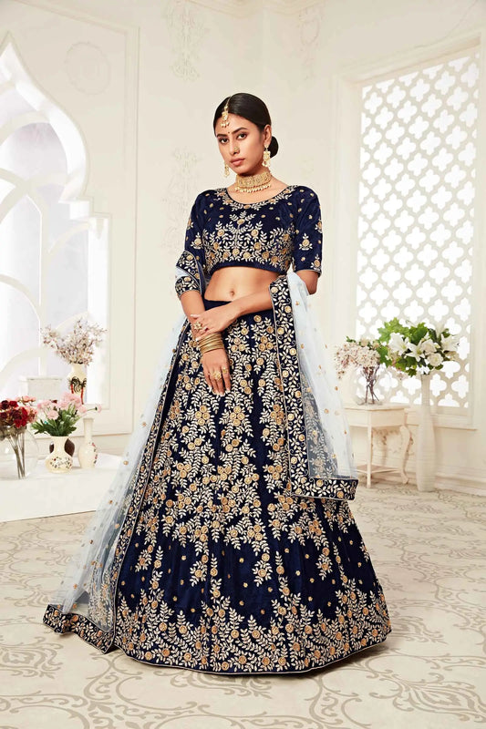 Navy blue velvet lehenga with zari and thread embroidery, adorned with diamond work