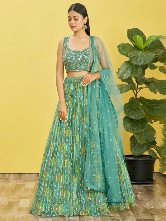 Lehenga set consisting of an embroidered pistachio green choli and a tulle dupatta