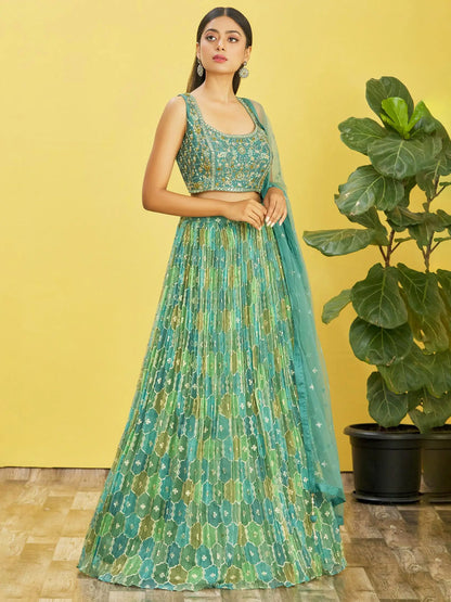 Lehenga set consisting of an embroidered pistachio green choli and a tulle dupatta