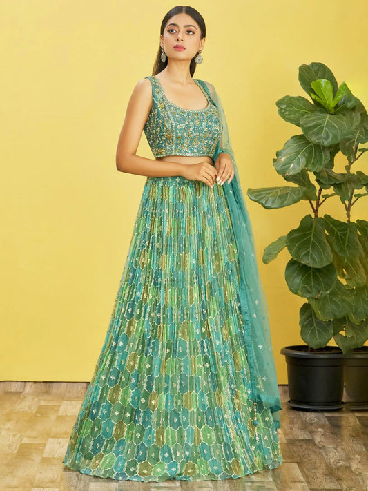 Lehenga set consisting of an embroidered pistachio green choli and a tulle dupatta