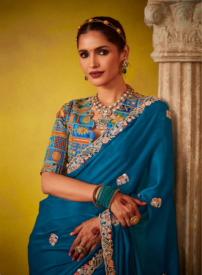 Teal blue glass silk fabric sari with multi-color blue blouse and digital print, sequin and thread embroidery