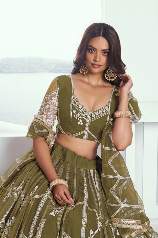 Olive green Lehenga Choli set in net fabric, adorned with delicate cotton thread embroidery and shiny sequins CHANDRALEKHA COLLECTION