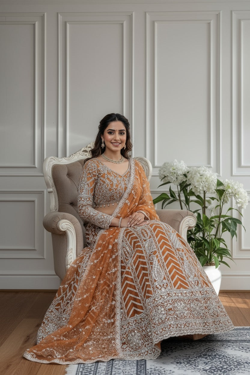 Lehenga orange rouille somptueux en butterfly net avec broderies de sequins